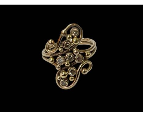 Seven stone diamond fancy design ring set in SGD stamped yellow gold, size T.