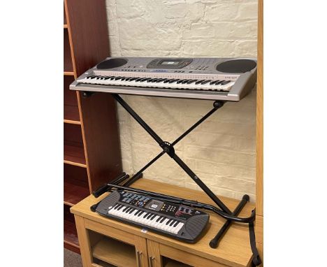 Two Casio electronic keyboards and stands.