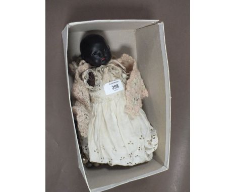 A VINTAGE GERMAN BLACK DOLL PLUS A SMALL QUANTITY OF COSTUME JEWELLERY