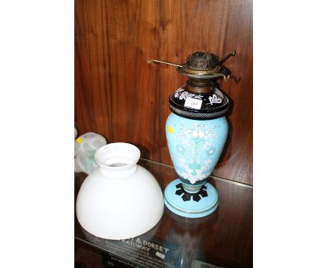 A VINTAGE FLORALLY PAINTED BLUE GLASS OIL LAMP WITH SHADE 
