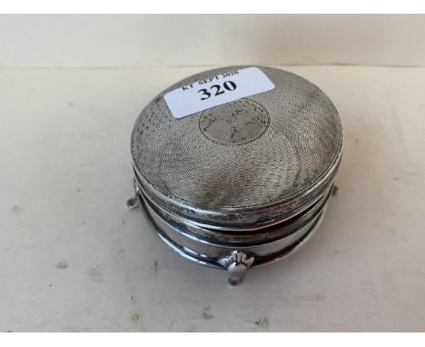 Circular silver trinket box with blue lined interior on 4 raised feet 