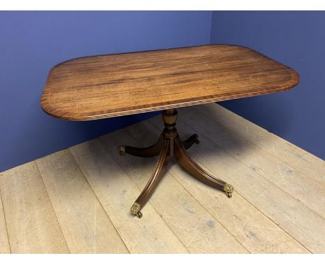 Regency style crossbanded mahogany pedestal breakfast table, swept legs to brass castors,   128 x 81 . Top, marks and scratch