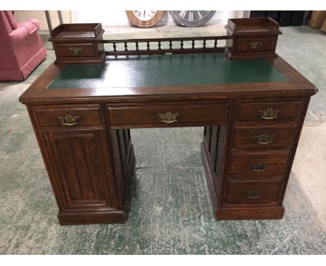 Late Victorian twin pedestal writing desk of 6 drawers and a cupboard, with a galleried back flanked by drawers, 123cmW 