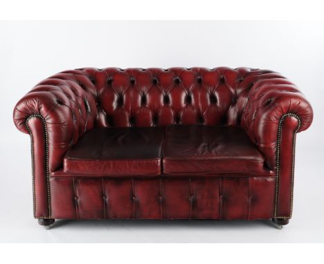 Sofa im Chesterfield-Stil, 20. Jh., Zweisitzer, roter Lederbezug, auf Rollen, 76 x 157 x 89 cm