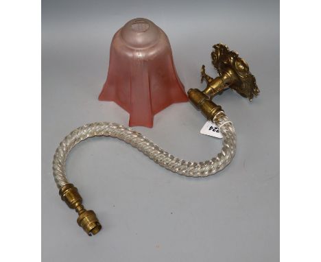 A cranberry shade and glass wall light