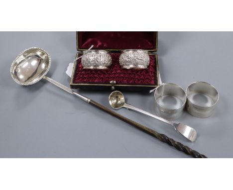 Two pairs of silver napkin rings (one cased), a George III ladle and a Georgian punch ladle with whale bone handle