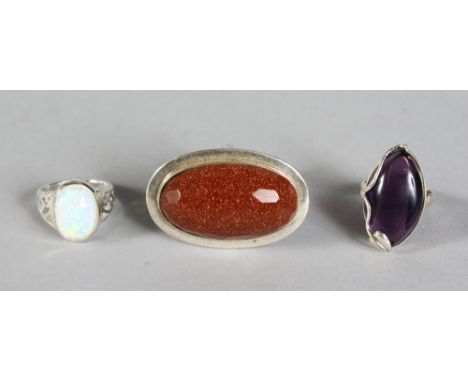 THREE SILVER RINGS, AMBER, OPAL AND AMETHYST.