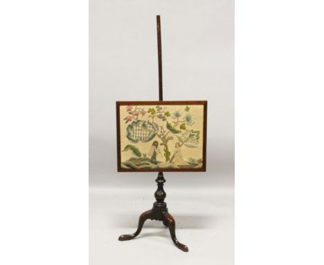 A GEORGIAN MAHOGANY POLE SCREEN, with needlework banner, on tripod legs.