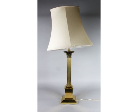 A LARGE CORINTHIAN COLUMN BRASS LAMP with shade.