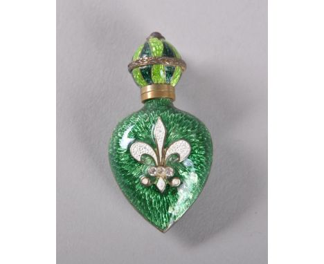 A SMALL RUSSIAN GREEN ENAMEL HEART SHAPED SCENT BOTTLE, one side with white fleur-de-lys.  4.5cms. Provenance: SOFFE, BANBURY