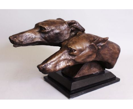 A BRONZE OF TWO GREYHOUND HEADS. 1ft 6ins long.