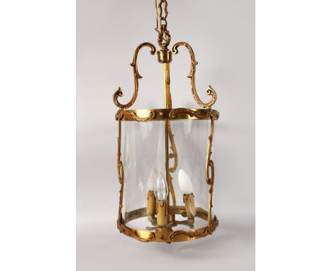 A GOOD BRASS CIRCULAR HANGING LANTERN with three electric candles. 24ins long, 10ins diameter.