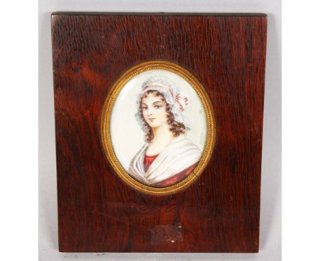 AN OVAL PORTRAIT OF A YOUNG GIRL, long hair , wearing a lace bonnet. Signed Simina. 2.5ins x 2ins.