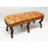 A GOOD GEORGIAN STYLE MAHOGANY STUDDED LEATHER STOOL on six unusual legs. 3ft 2ins long.