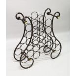 A WROUGHT IRON SHAPED CURVING BOTTLE STAND. 2ft 5ins high.