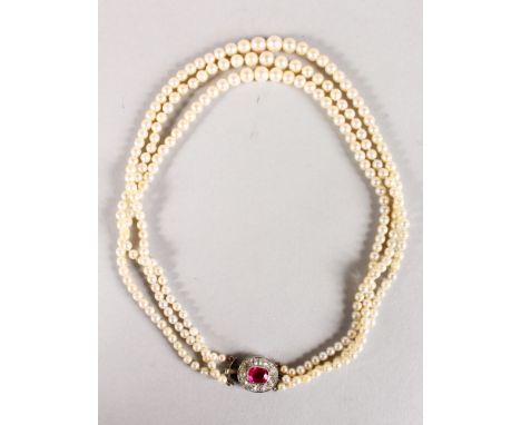 A VERY GOOD TRIPLE ROW PEARL NECKLACE with ruby and diamond clasp.