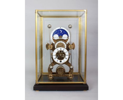 A GOOD SKELETON CLOCK with phases of the moon, in a glass case. 1ft 7ins high overall, 1ft wide.