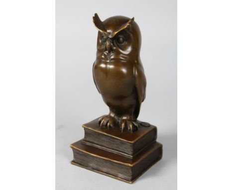 C. POTTER A BRONZE WISE OWL on TWO BOOKS. Signed.  9ins high.