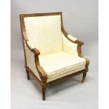 A GOOD FRENCH CARVED ARMCHAIR with silkwork back, arms and seat, on tapering legs.