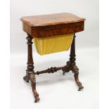 A VICTORIAN WALNUT SEWING TABLE, the folding top opening to reveal a writing surface, sliding sewing