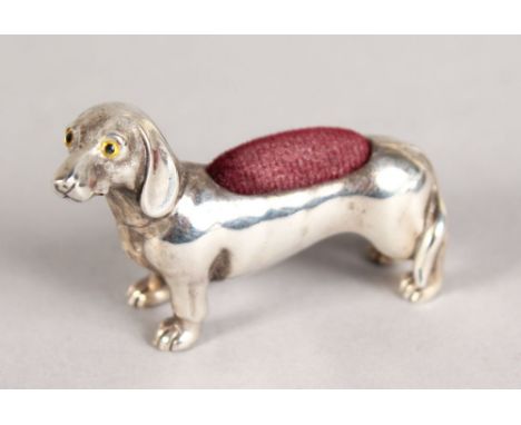 A NOVELTY SILVER DACHSHUND PIN CUSHION.