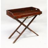 A GOOD MAHOGANY AND BRASS BOUND BUTLERS TRAY, on folding stand. 3ft 0ins long x 1ft 7ins deep x