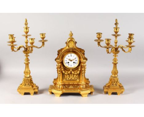 A GOOD 19TH CENTURY FRENCH ORMOLU CLOCK GARNITURE, signed Raingo Freres, Paris, with a white porcelain dial, blue enamel nume