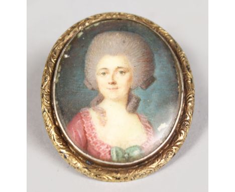 AN OVAL MINIATURE, AN 18TH CENTURY PORTRAIT OF A LADY. 1.75ins x 1.5ins.