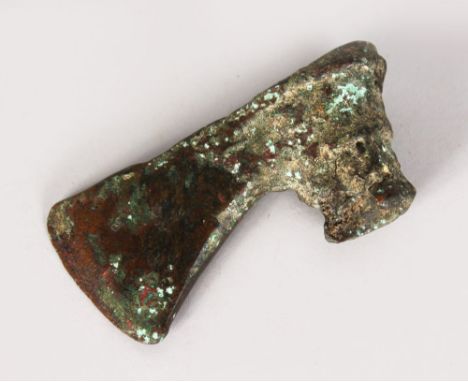 AN EARLY BRONZE AXE HEAD.  5ins long.