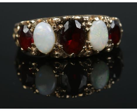 A 9ct gold five stone opal and garnet ring. Size O 1/2 Weight 3.2g  
