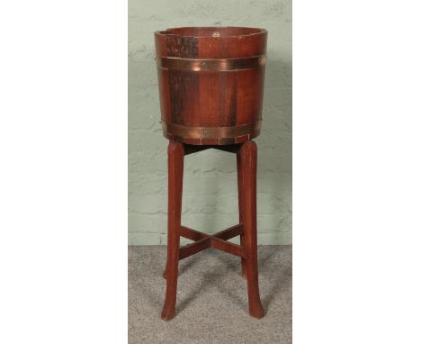 R. A. Lister & Co Ltd oak planter in barrel form on stand.Hx92cmWx36cm  