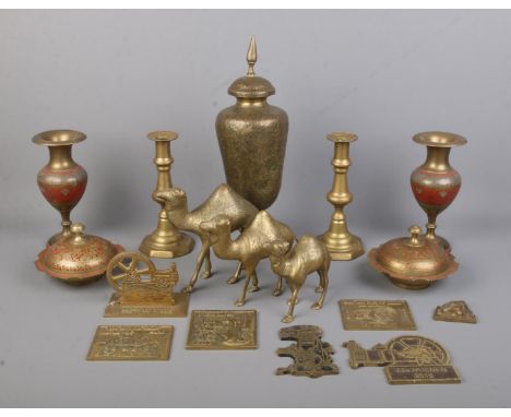 A collection of brass wares, to include a pair of candlesticks, lidded trinket dishes, graduated camels and Astel rally plaqu