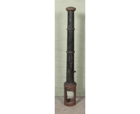 A Broxap black painted cast iron bollard. Height: 145cm.  