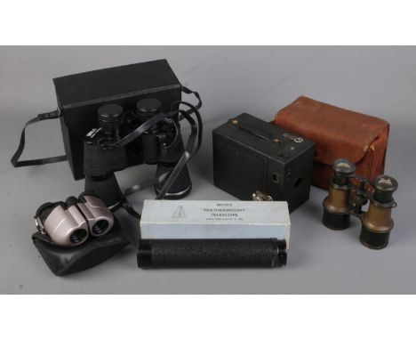 A box of assorted binoculars, photographic etc. Includes Britex Featherweight telescope, Sirus binoculars, Kodak box camera. 