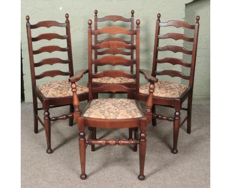 A set of four oak ladder back chairs. Includes one carver example.  