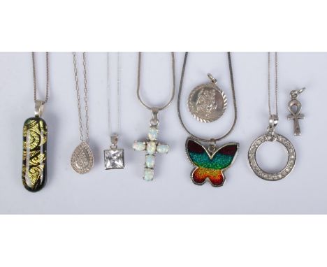 Six silver necklaces to include butterfly, glass, opal crucifix examples, etc. Total weight 37.3g.  