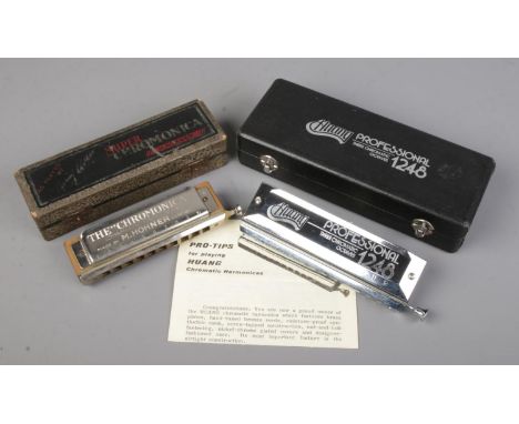 Two cased harmonicas. Includes Hohner Super Chromonica and Huang Professional 1248.  