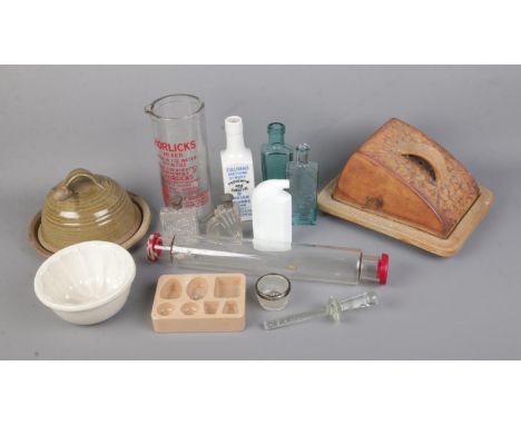 A collection of kitchen ceramics and glassware to include ceramic chocolate mould, glass rolling pin, Sullivan's Syrups bottl