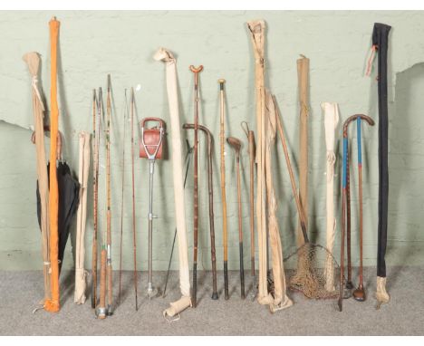 A collection of vintage sporting items consisting mainly of fishing rods including fly rods, two piece and three piece exampl