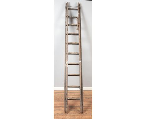 A wooden extendable ladder. Unextended length approximately 275cm.  