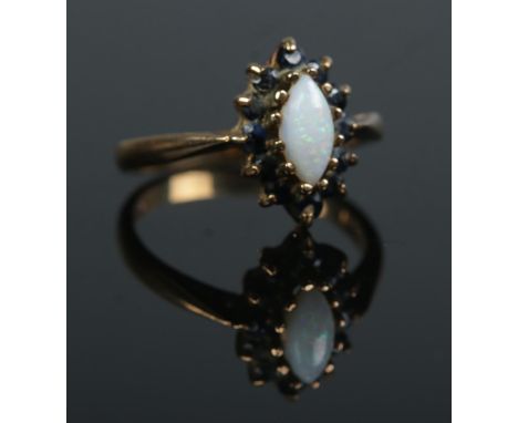 A 9ct gold, opal and sapphire ring. Size N 1/2. 3.1g.  