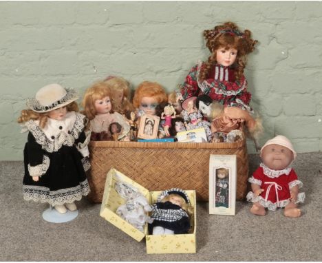 A basket of assorted dolls, including porcelain examples. Contains example in box with accessories, Leonardo collection, Matt