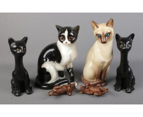 A ceramic Goebel cat together with a quantity of other cat figures.  