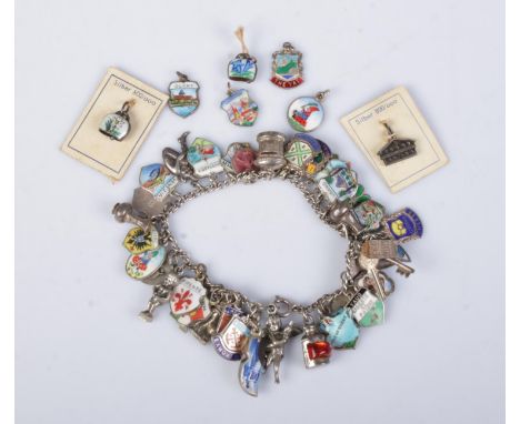 A silver and white metal charm bracelet. Made up of mostly Continental silver and enamel charms. Gross weight 56g.  