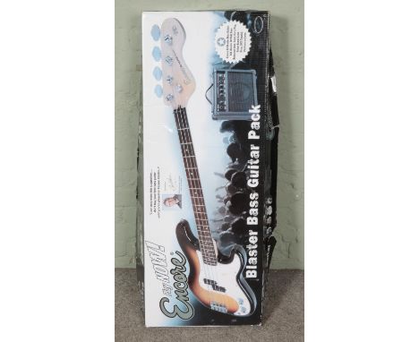 A left handed Encore Blaster Series bass guitar in original box with mini amplifier and other accessories.  