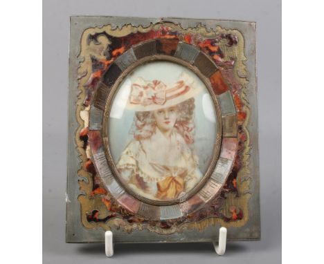An antique portrait of a maiden in tortoiseshell inlaid frame. Signed Pirot. Frame measures 13cm x 11cm.  