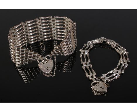 A silver gate link bracelet with heart padlock clasp and safety chain together with a smaller example.Large example assayed L