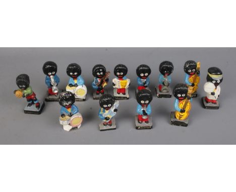 A collection of assorted Robertson Golly figures includes mostly musicians along with football player and lollipop man. Sever