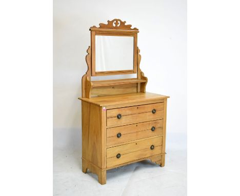 Early 20th Century stripped pine dressing chest, with rectangular mirror plate over trinket shelf, the lower stage of three l