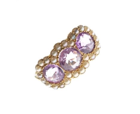 18ct gold dress ring set three amethyst coloured stones within seed pearl border, size R, 4g gross approx  